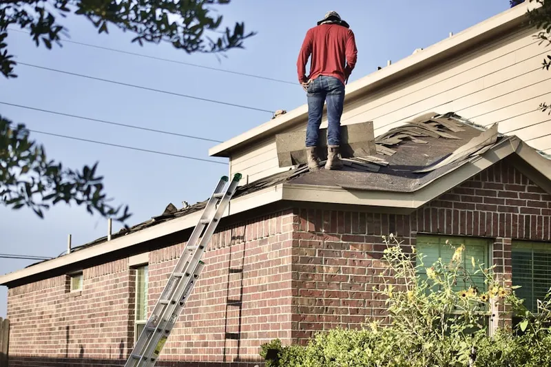 Professional roofer working on a residential roof in Rockburn Commons